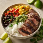 Cilantro lime steak bowls topped with fresh cilantro and lime wedges