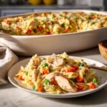 Creamy chicken pot pie orzo served in a bowl with vegetables and herbs