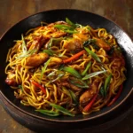Delicious Garlic Chicken Lo Mein topped with fresh vegetables and savory sauce.