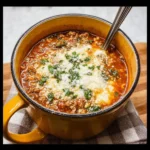 Bowl of Keto Lasagna Soup topped with cheese and herbs, a low-carb dish.