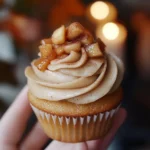 Delicious apple pie cupcakes topped with cinnamon and whipped cream