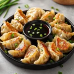 Delicious chicken potstickers served with dipping sauce on a plate