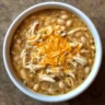 Bowl of healthy white chicken chili topped with cilantro and lemon slices