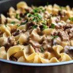 Delicious Ground Beef Stroganoff served on a plate with fresh parsley.