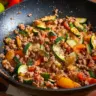 Healthy Italian Ground Turkey and Veggie Skillet dish on a wooden table