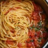 Delicious One Pot Pasta dish garnished with herbs and vegetables