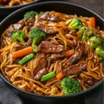 Plate of Beef Lo Mein with vegetables and sliced beef stir-fried to perfection
