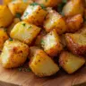 Golden brown crispy roast potatoes served in a rustic dish