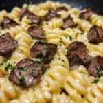 Delicious buttery steak and cheesy shells skillet, showcasing rich flavors and creamy texture.