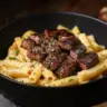A delicious plate of Cajun Steak Pasta with steak slices and creamy sauce