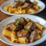 Cajun Steak Tips served with Cheesy Rigatoni on a plate