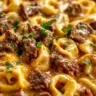 Cheesesteak Tortellini dish featuring stuffed pasta with beef and cheese