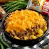 Delicious cheesy ground beef and potato casserole served in a baking dish