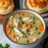 Bowl of creamy Chicken Pot Pie Soup topped with fresh herbs