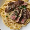 Creamy Steak Alfredo served with Fettuccine pasta on a plate