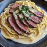 Creamy steak pasta infused with garlic for a rich, flavorful dish.