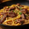 Indulgent creamy Cajun Butter Steak Pasta in a skillet ready to serve