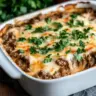 Keto Beef Stroganoff Casserole topped with fresh herbs in a baking dish