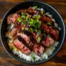 Korean BBQ Steak Rice Bowl with spicy cream sauce served in a bowl