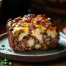 Delicious Loaded Potato Meatloaf topped with melted cheese and crispy bacon