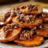 Delicious melting sweet potatoes served on a plate, showcasing their creamy texture.