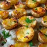 Plate of mini smashed potatoes garnished with herbs and spices