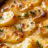 Creamy Potatoes Au Gratin baked to perfection with cheese and herbs