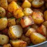 Bowl of crispy roasted mini potatoes seasoned with herbs and spices
