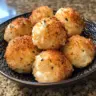 Air fryer cheesy mashed potato balls served with dip on a plate