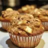 Freshly baked apple cinnamon Greek yogurt muffins on a cooling rack.