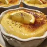 Baked lemon pudding served in a ramekin with lemon zest garnish
