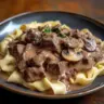 Delicious Beef Stroganoff served with noodles and garnished with parsley