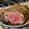 Succulent Christmas Prime Rib garnished with herbs for the holiday dinner.