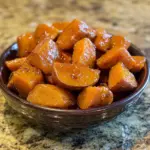 Delicious brown sugar candied sweet potatoes served in a festive dish