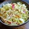 Bowl of Cabbage Apple Slaw with fresh ingredients