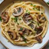 Caramelized leek and mushroom pasta with Gruyere cheese served in a bowl.