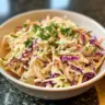 Bowl of classic coleslaw with shredded cabbage and dressing