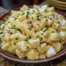 Bowl of classic potato salad with herbs and dressing
