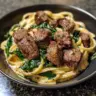 Creamy cowboy butter linguine topped with steak bites and fresh spinach