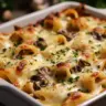 Creamy garlic mushroom stuffed shells topped with cheese and herbs.