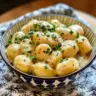 Creamy garlic sauce over baby potatoes, a delicious side dish for any meal.