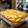 Creamy leftover ham potato casserole with cheese and herbs in a baking dish