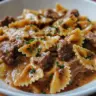 Creamy Parmesan garlic beef bowtie pasta served on a plate