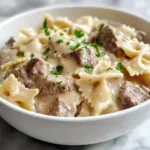Creamy Parmesan garlic beef bowtie pasta dish served in a bowl