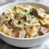 Creamy Parmesan garlic beef bowtie pasta dish served in a bowl