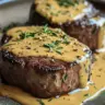 Delicious Filet Mignon topped with creamy mustard and Parmesan sauce, garnished beautifully.