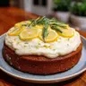 Fluffy lemon rosemary cake with lemon cream cheese frosting on a plate