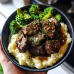 Juicy garlic butter steak bites served in a sizzling skillet with herbs.