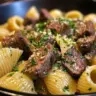 Delicious garlic butter steak bites served with creamy parmesan shells