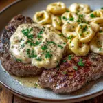 Delicious Garlic Butter Steak paired with Cheesy Alfredo Tortellini on a plate